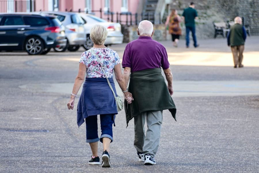 Older couple walking together on a tree-lined street